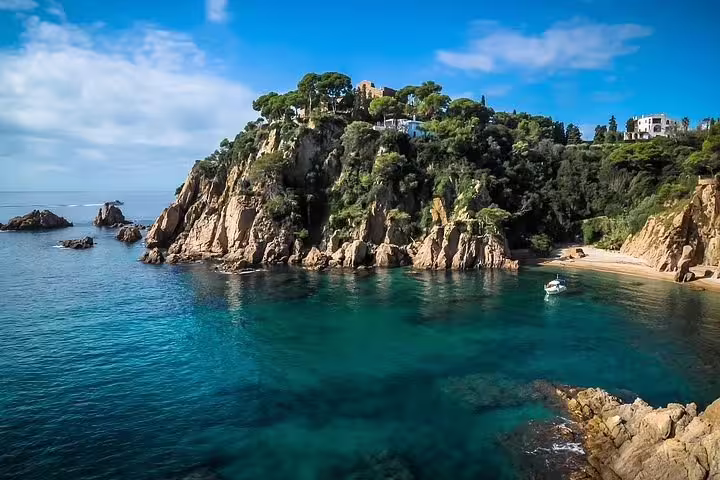 Scenic Costa Brava coastline with lush cliffs and clear blue waters, ideal for nature lovers and adventure seekers.