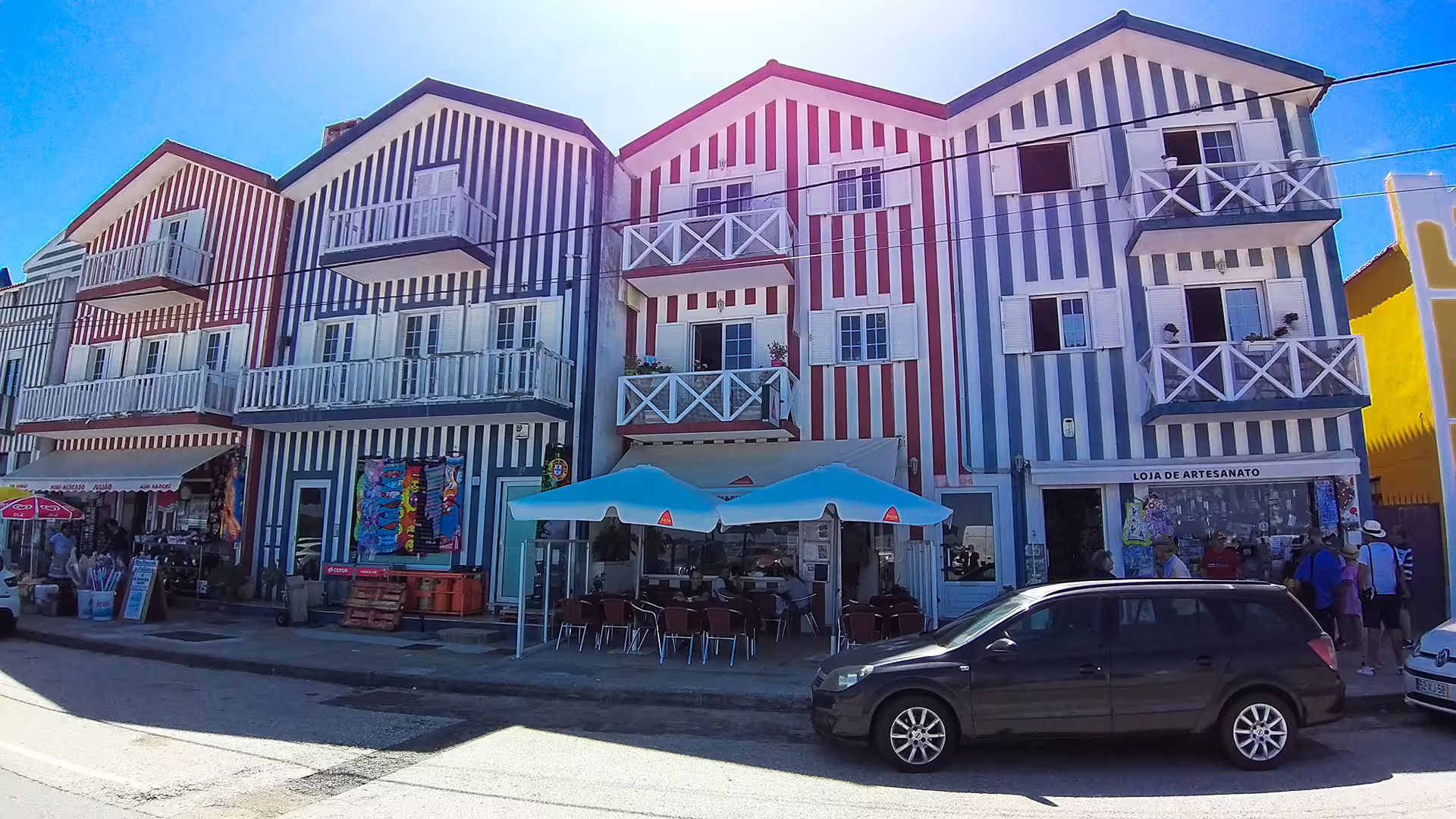 Colorful striped houses in Costa Nova, Portugal, showcasing vibrant architecture on the Aveiro and Costa Nova private tour.