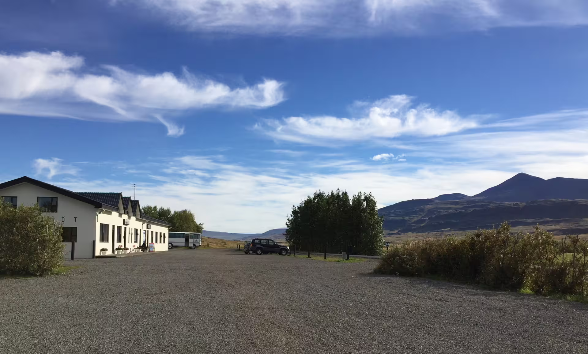 Scenic view of a countryside lodge with a clear blue sky, ideal starting point for family river rafting adventures.