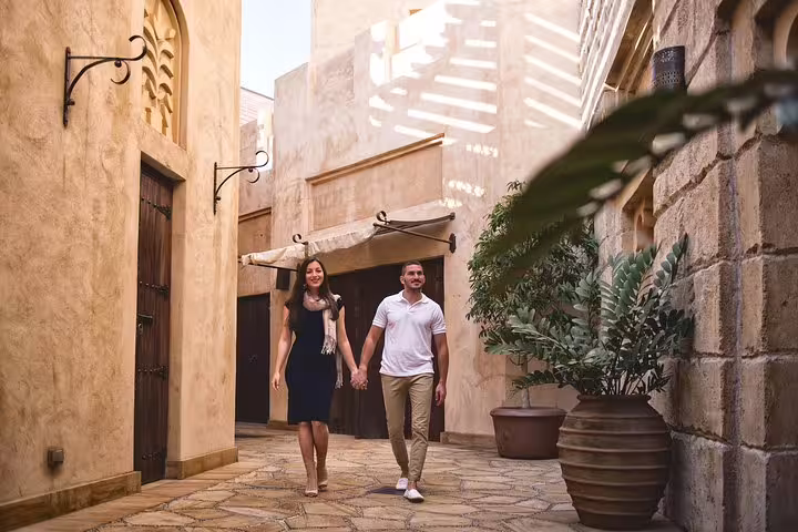Couple walking in Al Fahidi Historical Neighbourhood during private Dubai tour with personal photographer