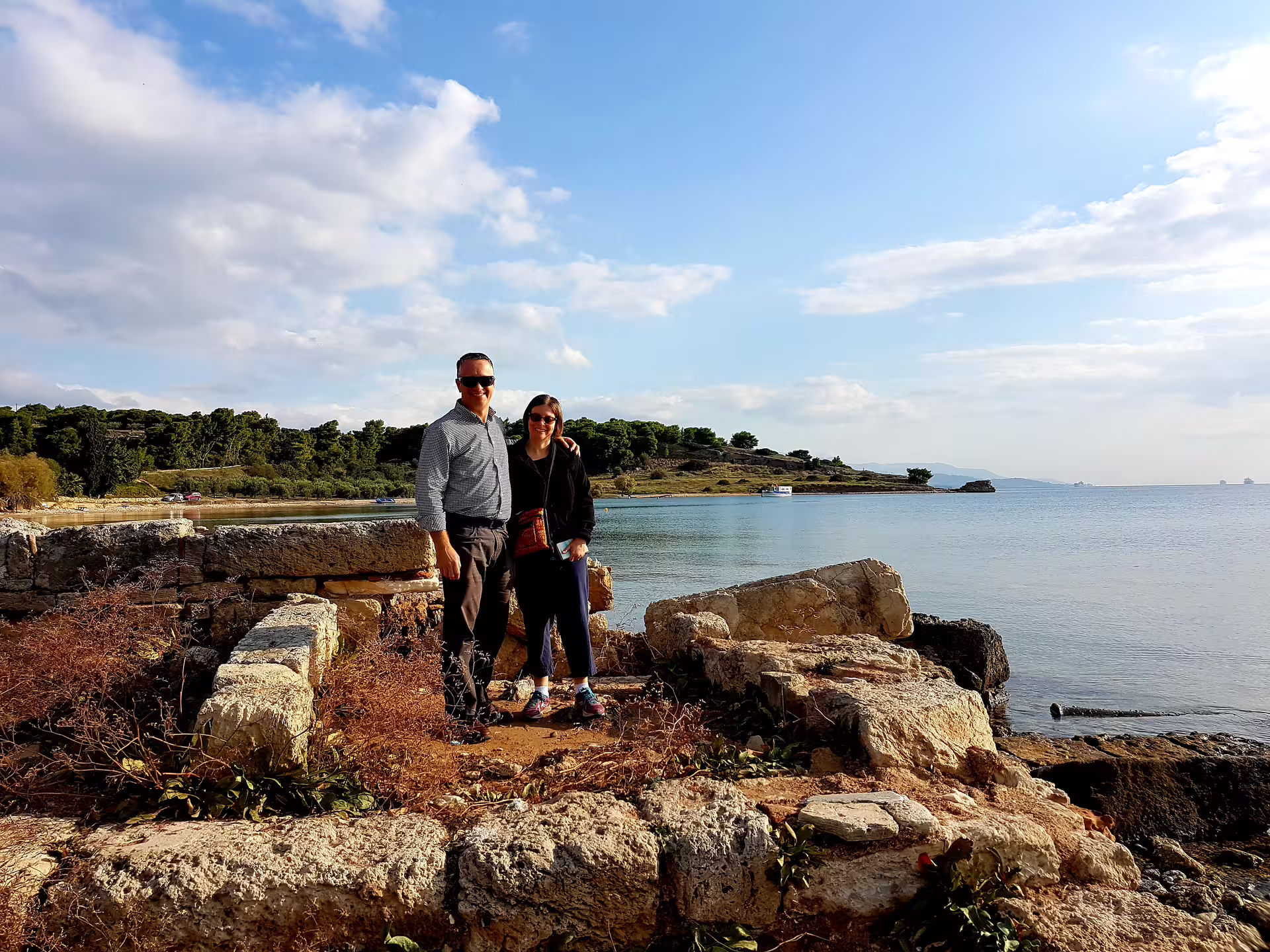 Couple at seaside ruins on a private Athens day trip toward Ancient Corinth, Epidaurus and Isthmus Canal