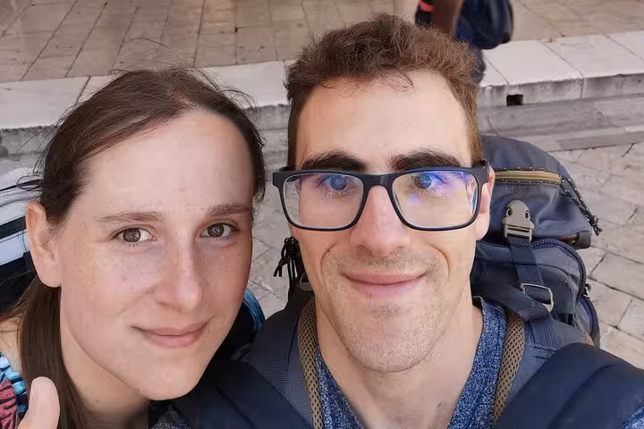 Couple with backpacks taking a selfie in Dubrovnik Old Town during a self-guided walking tour
