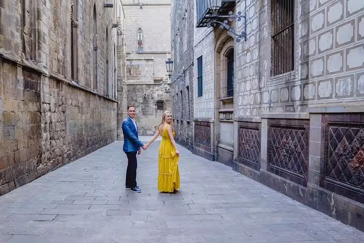 Couple holding hands in Barcelona Gothic Quarter alley during a private tour with personal travel photographer