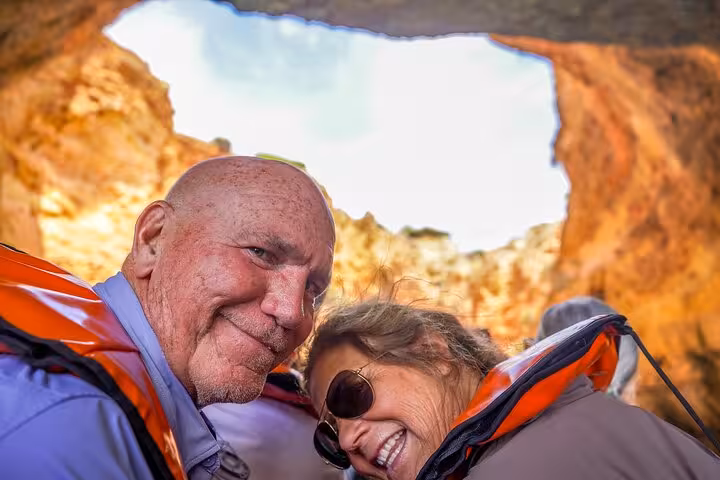 Couple on boat inside Benagil Cave Algarve, highlight stop on all inclusive private tour from Lisbon