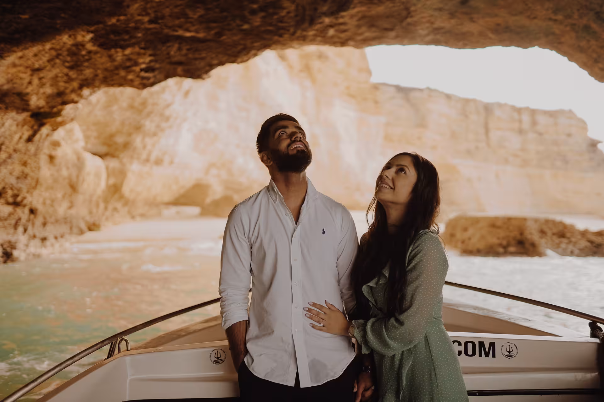 Couple admiring rock formations inside Benagil Cave on a private sunset boat tour along Portugal’s Algarve coast