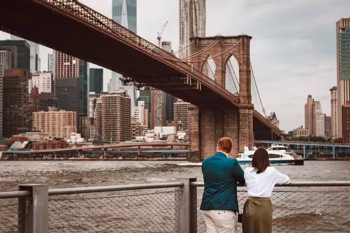 Couple enjoying the scenic view of Brooklyn Bridge and Manhattan skyline on a private New York travel photographer tour.