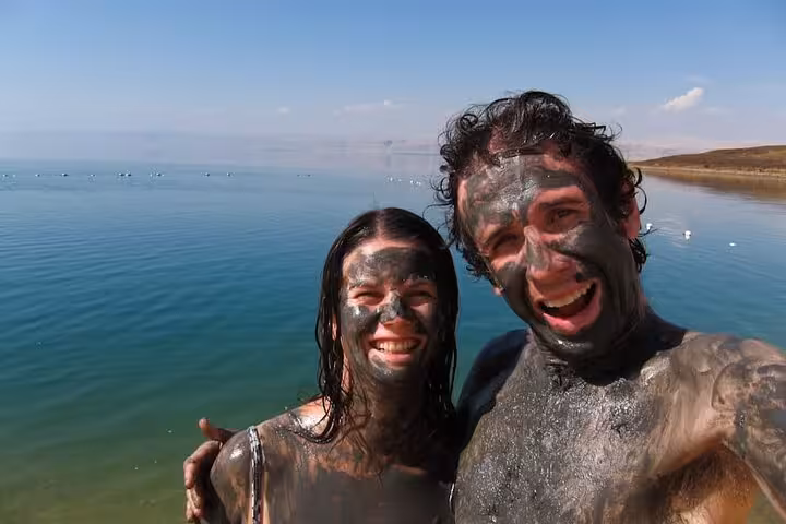 Couple covered in Dead Sea mud selfie in Jordan, wellness stop on 13-day Egypt Jordan Jerusalem tour