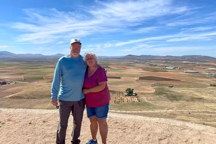 Couple overlooking the vast scenic landscape of La Mancha on the Don Quixote Windmills tour.