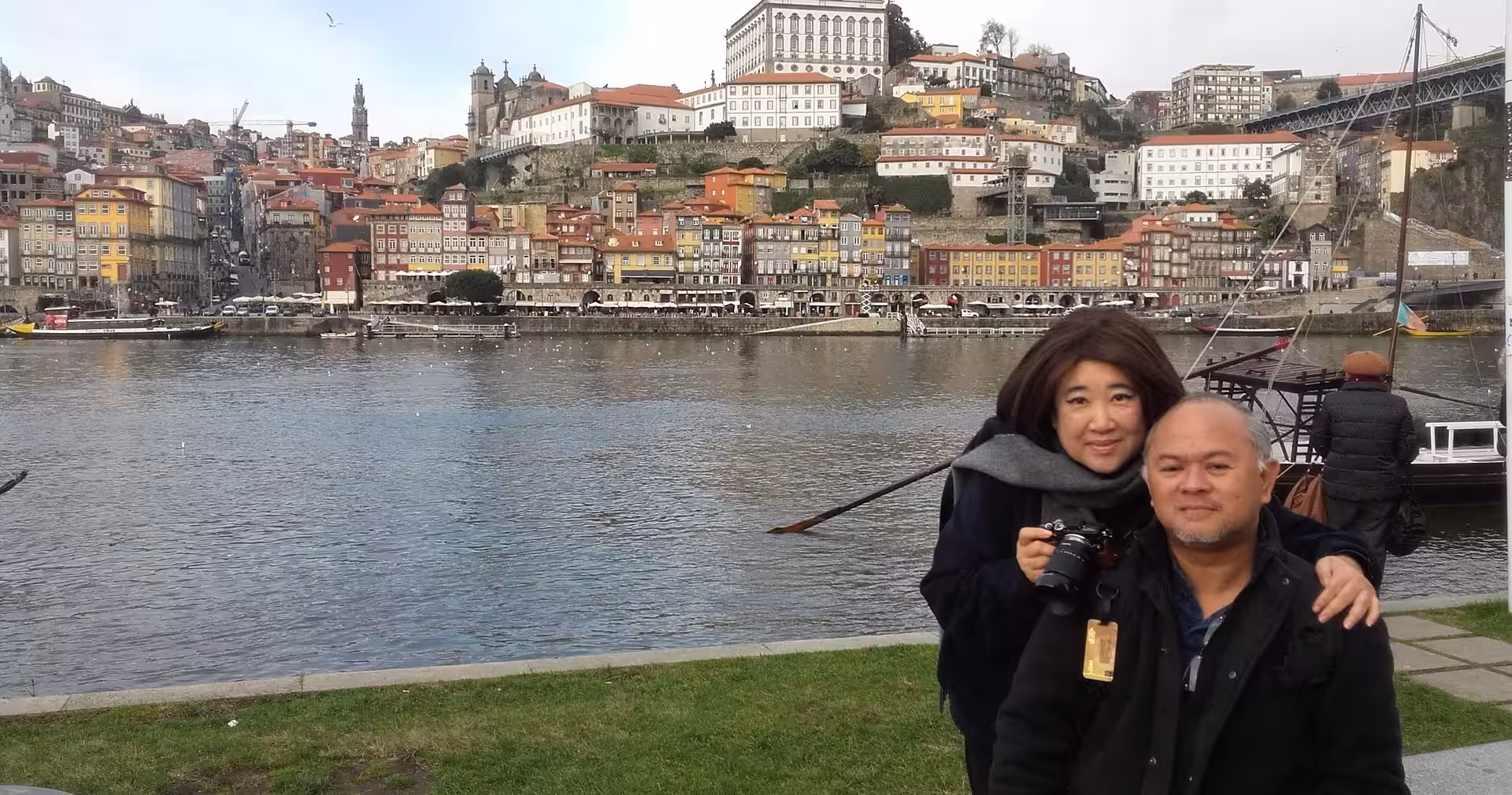 Couple by the Douro River in Porto on 7-day Portugal tour from Lisbon to Porto, Ribeira skyline backdrop