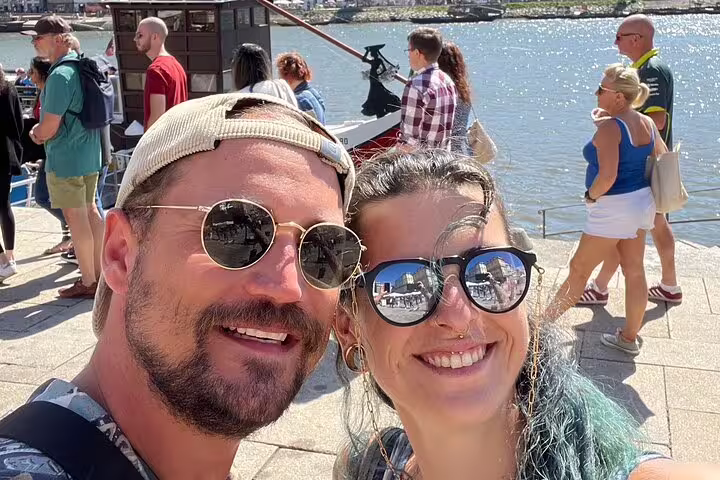 Couple selfie by the Douro River in Porto during a self-guided scavenger hunt sightseeing walking tour