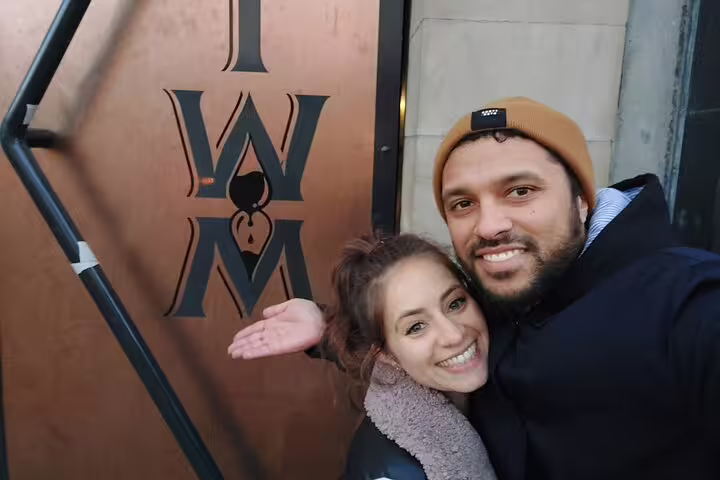 Couple smiling together outside IWM building entrance on Dublin romantic walking tour