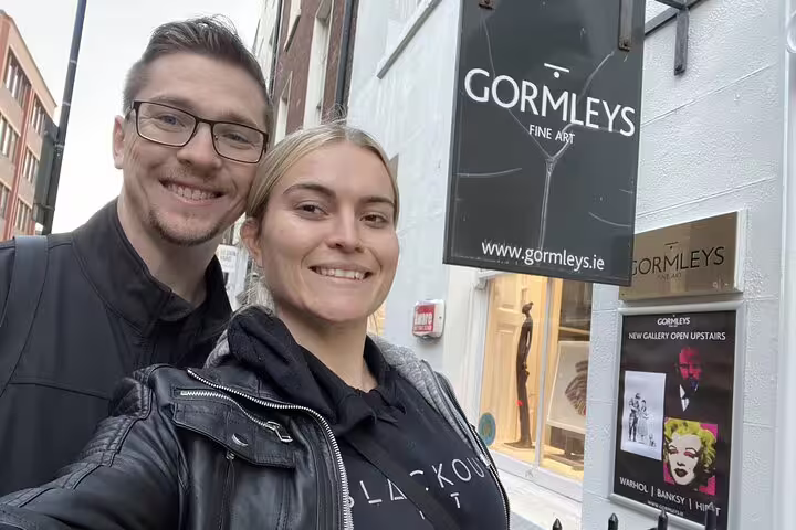 Couple smiling outside Gormleys Fine Art gallery in Dublin during a romantic walking tour