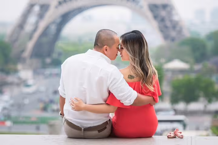 Couple embracing near Eiffel Tower in Paris during romantic photo shoot session