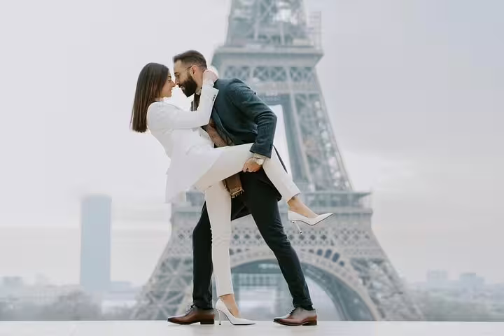 Couple embracing in front of the Eiffel Tower in Paris during a private photoshoot tour