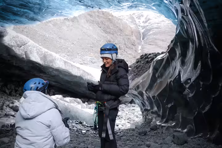 Couple sharing a romantic elopement moment inside a stunning blue glacier ice cave on a private glacier experience tour