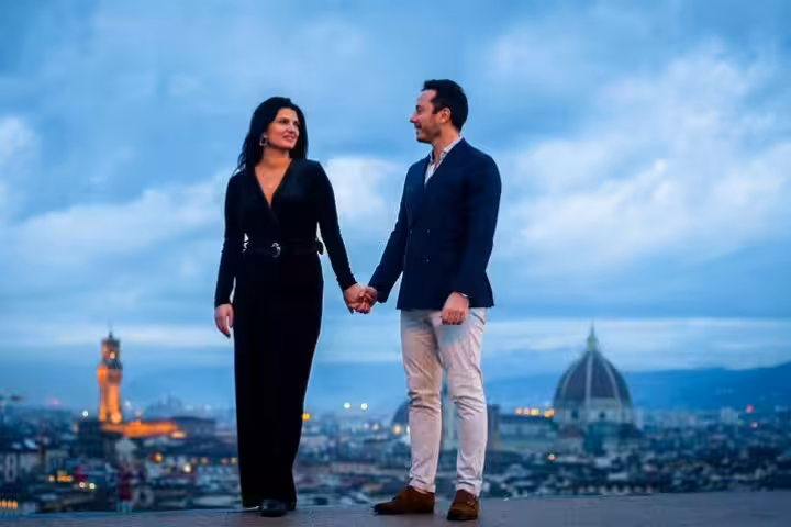 Couple posing on a Florence viewpoint with Duomo skyline at dusk, personal travel photographer photo tour