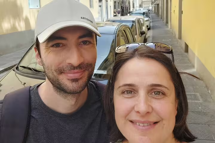 Couple smiling on a narrow street in Florence during a self-guided walking tour