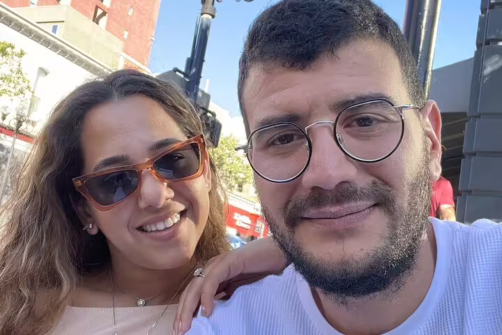 Smiling couple posing outdoors in Gaslamp Quarter San Diego on walking tour