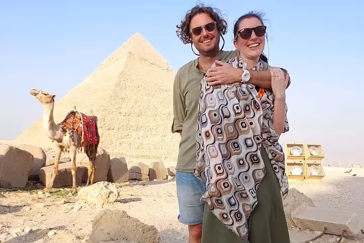 Couple photo at Giza Pyramids with camel in desert, all-inclusive guided Cairo day trip to Saqqara Memphis