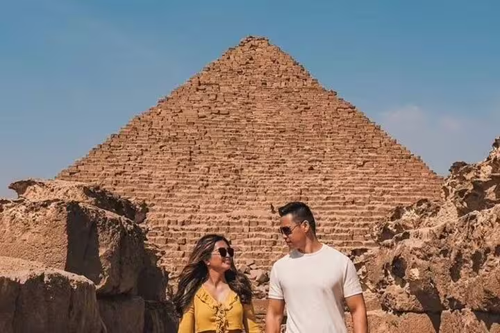 Couple at the Great Pyramid of Giza on a private tour from Alexandria Port, Egypt day trip excursion
