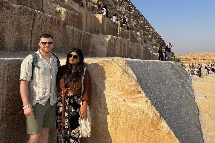 Couple posing by Great Pyramid stone blocks in Giza, Cairo on 3-day private sightseeing tour Egypt