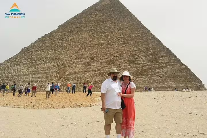 Couple posing by the Great Pyramid of Giza on 8 days 7 nights Jewels of Egypt tour with Luxor and Aswan