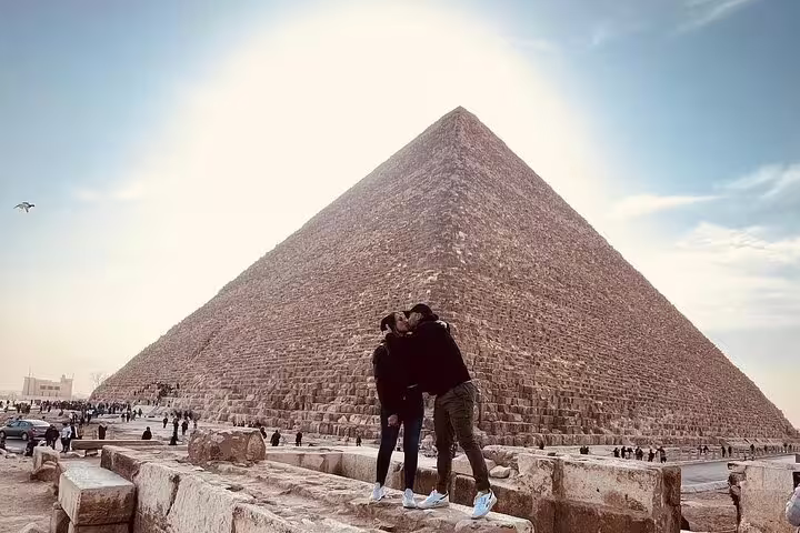Couple posing at the Great Pyramid of Giza on a private Port Said shore excursion with Cairo museum visit