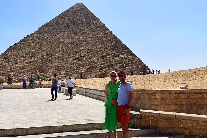 Couple posing by the Great Pyramid of Giza on a private guided tour from Cairo airport or hotel pickup