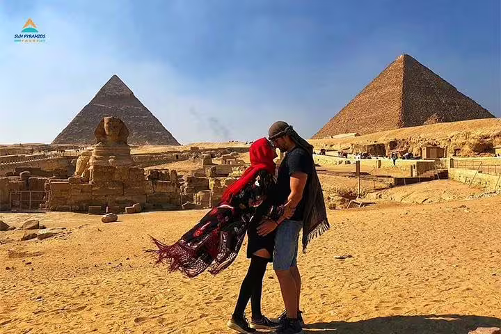 Couple by Great Sphinx and Giza Pyramids, Cairo stop on 12 day 11 night Egypt tour to Luxor, Aswan and Hurghada
