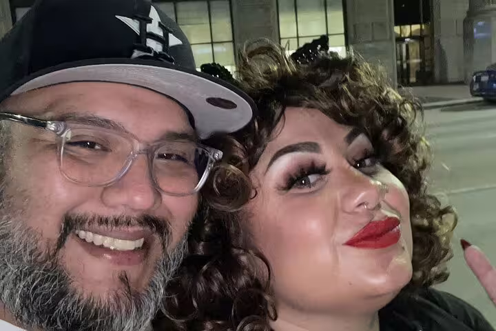 Couple smiling together at night in Houston for a haunted walking tour