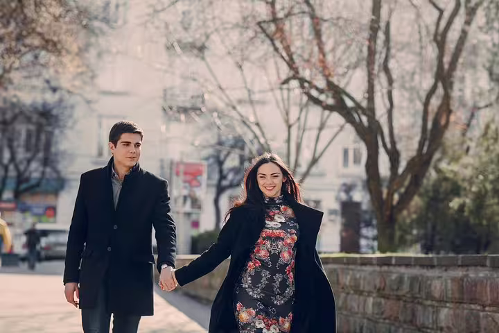 Couple holding hands on a Milan street, captured on a private travel photographer tour with candid portraits