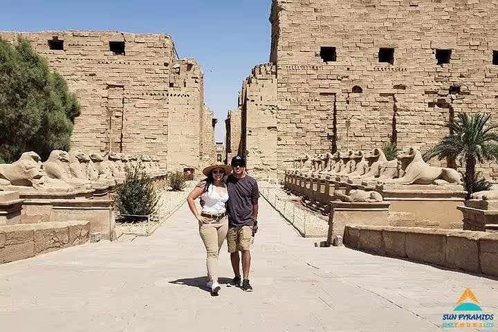 Couple walking Karnak Temple avenue of sphinxes in Luxor, highlight of 12 day 11 night Egypt tour package