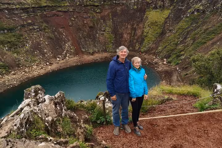 Couple posing at Kerid volcanic crater lake on Golden Circle tour from Keflavik Airport