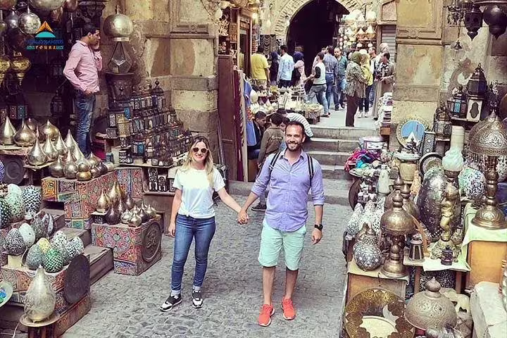 Couple exploring Khan El Khalili bazaar Cairo on private Dahab to Cairo flight day tour shopping souvenirs