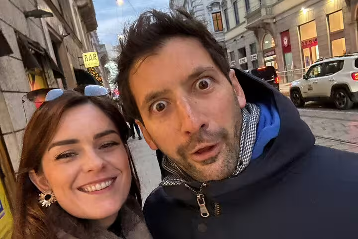 Couple smiling on a Milan city street during a self-guided walking tour