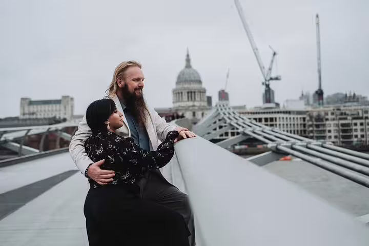 Couple enjoying scenic views from Millennium Bridge, capturing memories on a private London photo tour.