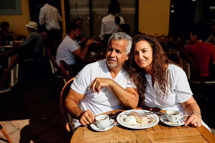 Couple at a Monaco cafe during a private tour with personal travel photographer, lifestyle dining photo session