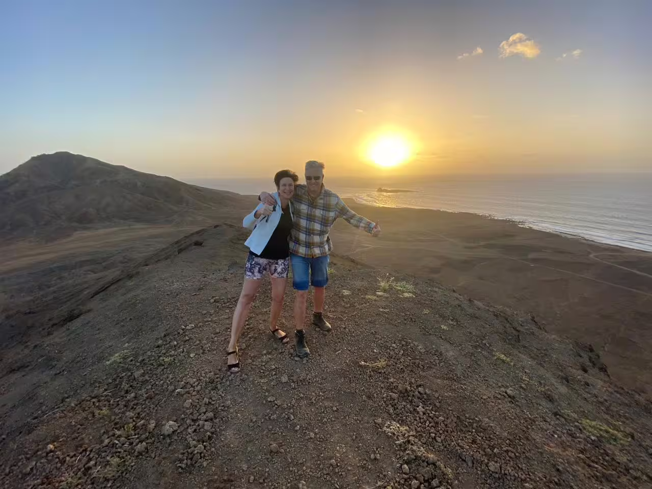 Couple at Mount Lion summit during sunset hike, enjoying panoramic ocean views on a guided trail tour