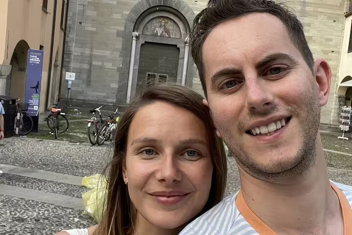 Couple smiling during self-guided murder mystery walking tour in Como city square