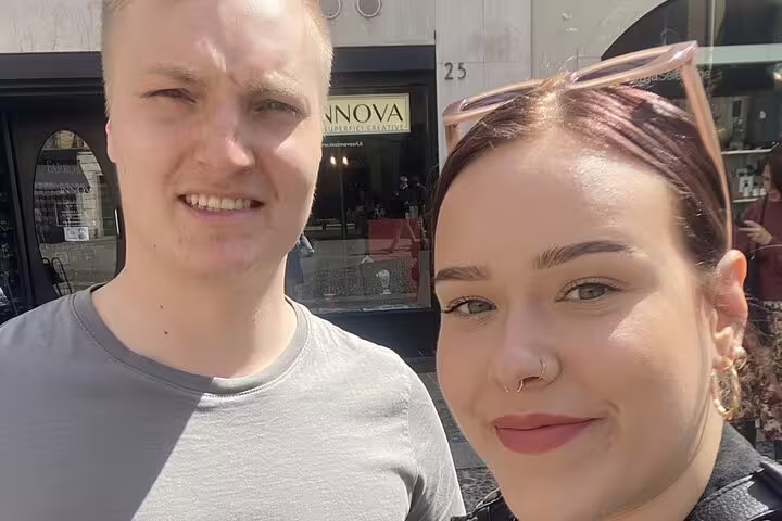 Couple smiling on a sunny street in Como, Italy during a self-guided walking tour