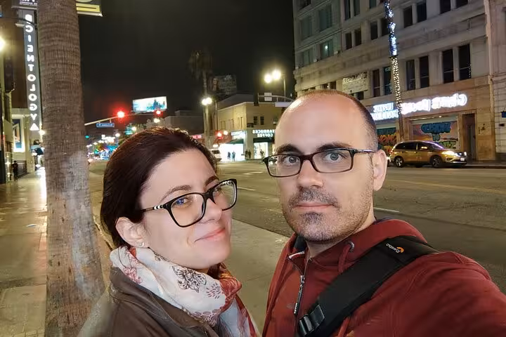Couple taking a selfie at night on a Hollywood street during a ghost hunt walking tour