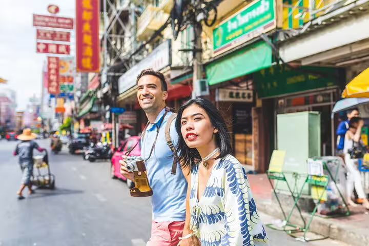 Couple exploring Osaka street markets on a private photoshoot, showcasing vibrant local culture and architecture.