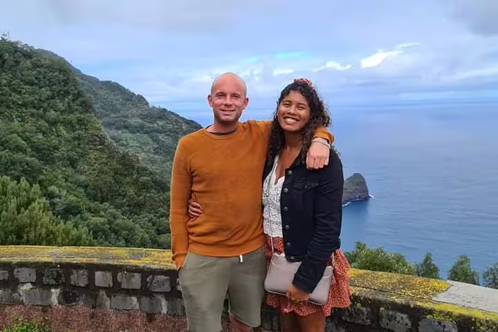 Couple enjoying panoramic ocean views from a lookout on Madeira's eastern tour.