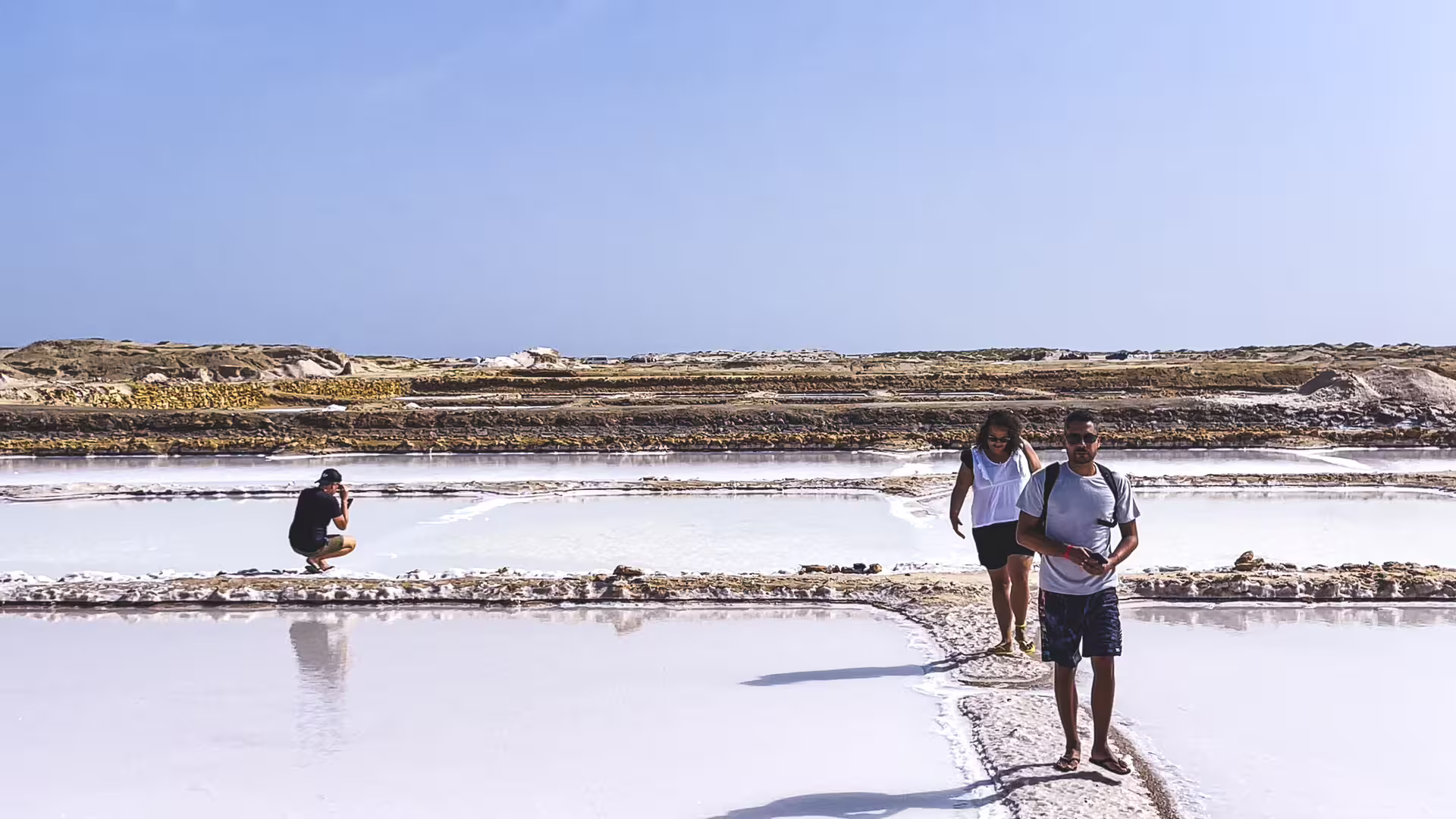 Couple walking the Pedra de Lume salt flats on an all-inclusive Sal Island day tour with lunch and fees