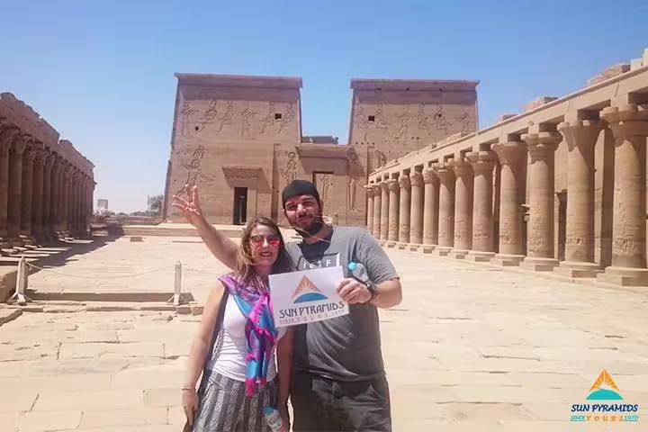 Couple at Philae Temple complex in Aswan, Egypt, part of 15 days 14 nights Pyramids Luxor Aswan Oasis package