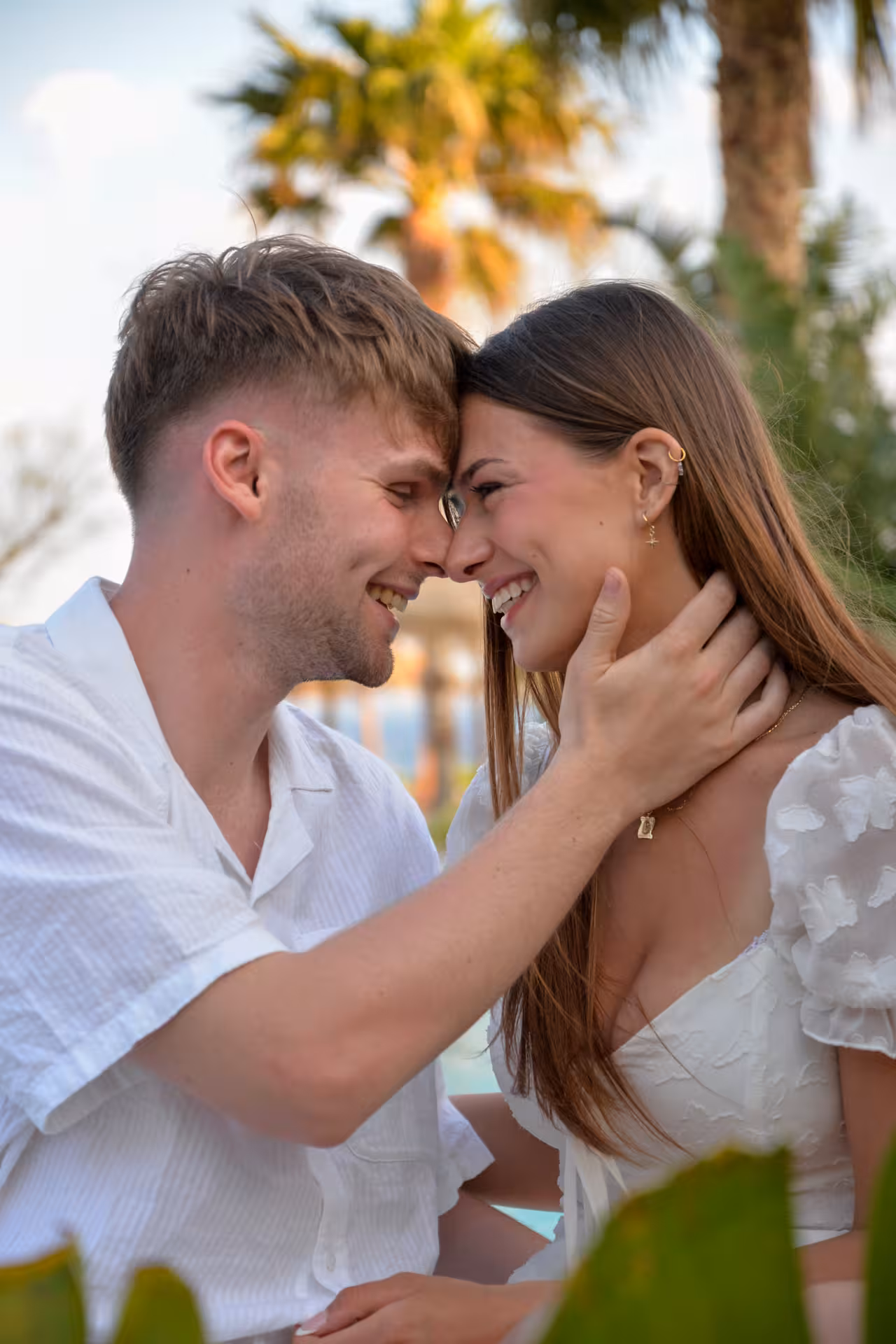 Happy couple sharing a tender moment during a photoshoot at Heraklion Venetian Port.