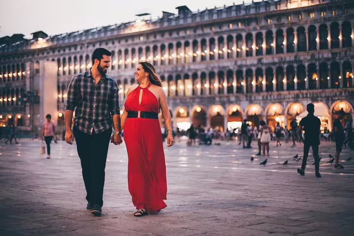 Couple strolling in Piazza San Marco at dusk, romantic Venice proposal photographer session with golden lights