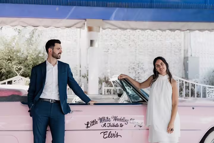 Couple posing by pink Elvis wedding car in Las Vegas, shot on personal vacation photographer tour