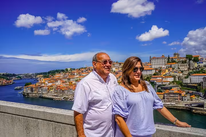 Couple overlooking Porto riverside panorama on Portugal pilgrimage tour from Fátima to Santiago and Nazaré