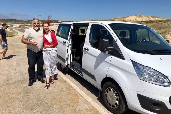 Couple enjoying a private Lisbon city tour with a spacious van, perfect for exploring scenic Portugal with comfort and flexibility.